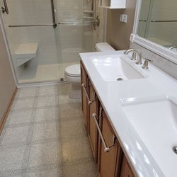 Excel Shower & Bath - Tub to shower conversion (& enlargement), including custom barn door style glass doors & vanity top replacement