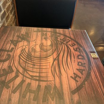 Hot Rocks Pizza Kitchen - a table with a sign on it - Pizza Near Me - Kansas City, Missouri