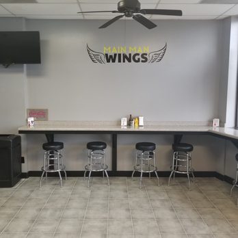 Main Man Wings - a bar with stools and a ceiling fan - Chicken Wings Near Me - Jonesboro, Georgia Main Man Wings - a bar with stools and a ceiling fan - Chicken Wings Near Me - Jonesboro, Georgia