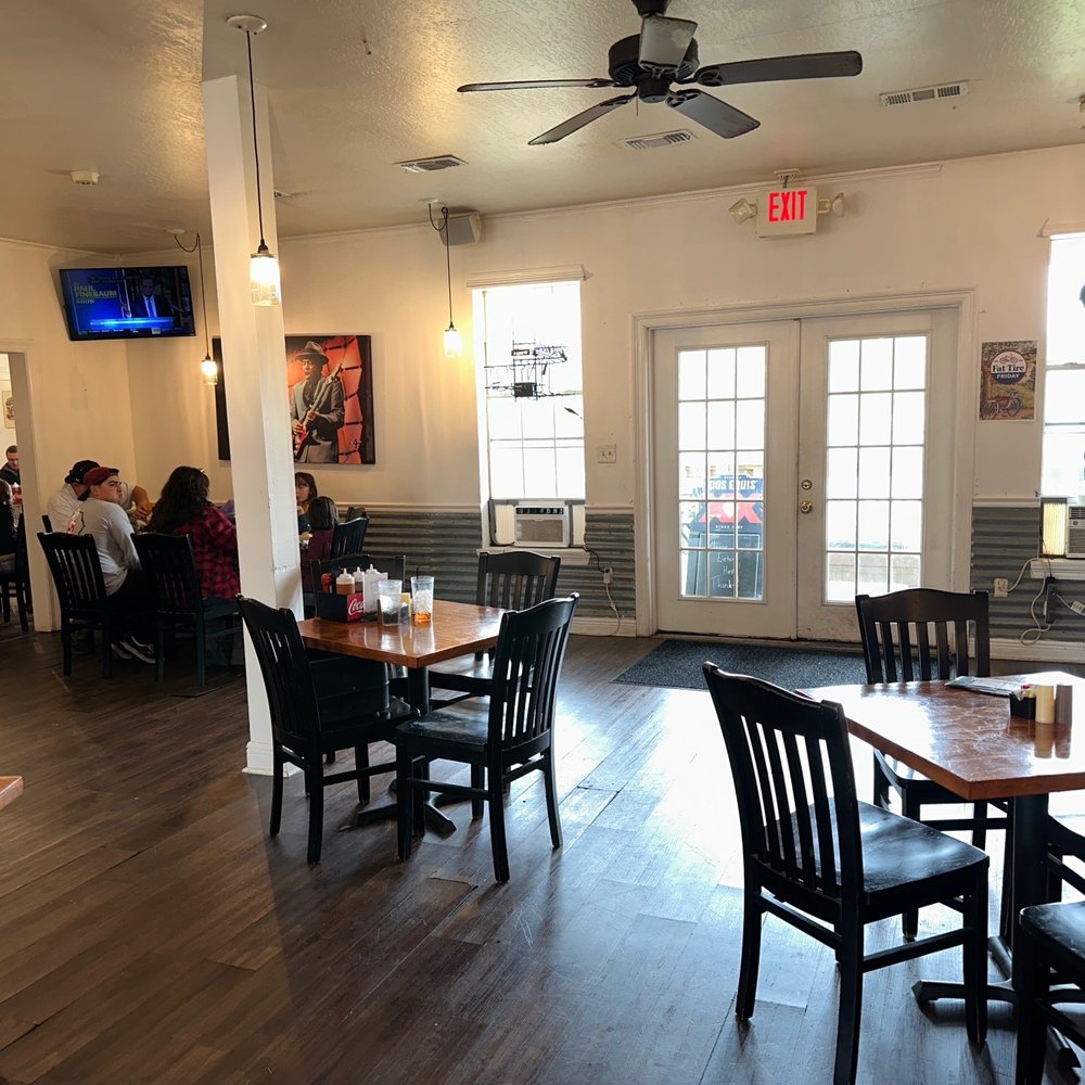 a restaurant with tables and chairs a restaurant with tables and chairs