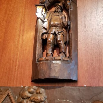 Von Trier - a wooden relief of a man on a horse - Pubs Near Me - Milwaukee, Wisconsin