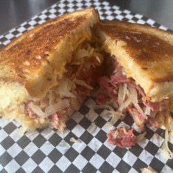 The Den Restaurant - Reuben made with corned beef, Swiss cheese, sauerkraut and house-made Reuben sauce