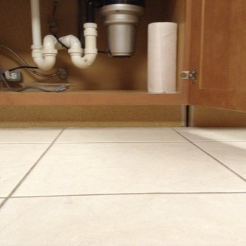 American Decorating Outlet - Plumbing leaking into a pie plate to prevent damaging new cabinets that ADO installed. - Interior Design Near Me - Sarasota, Florida