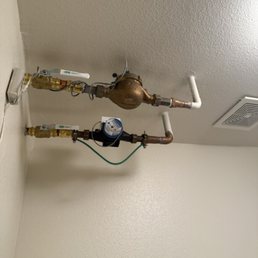 Pipes sticking out of ceiling in laundry closet