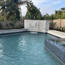 Waterfall feature wall that also hides pool equipment Waterfall feature wall that also hides pool equipment