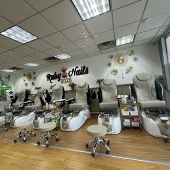 Ruby Nails - Beautiful salon. Love the decor. Very cute! - Interior of a nail salon featuring multiple massage chairs, small rolling stools, and decorative wall art with the Ruby Nails 2025 logo. - Nail Salons Near Me - Weymouth, Massachusetts