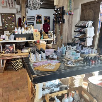 Luna and Luz - A boutique shop interior featuring a display table with skincare, jewelry, and decorative items, with artwork and accessories in the background. - Jewelry Near Me - Albuquerque, New Mexico
