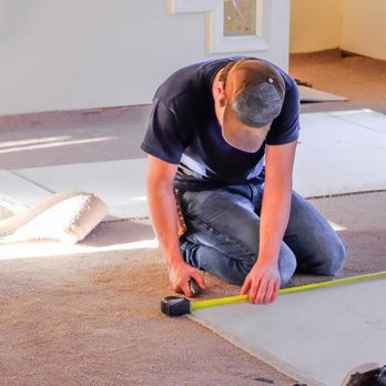Rocio's Carpet - a man using a tape measure - Flooring Near Me Rocio's Carpet - a man using a tape measure - Flooring Near Me