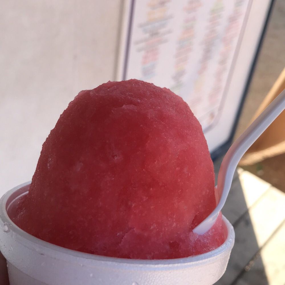 a hand holding a cup of watermelon