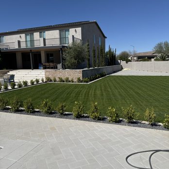 Nico's Landscaping - Cypress trees and brick wall - Landscaping Near Me
