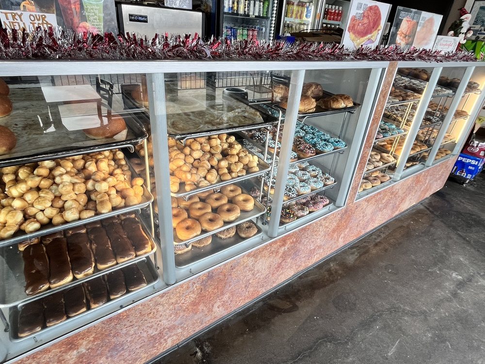 Full display case of fresh donuts