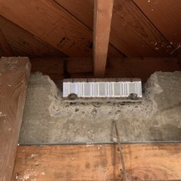 Bracing on a concrete retainer wall at basement of house.