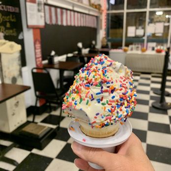 Taylor's Ice Cream Parlor - a hand holding a frosted donut with sprinkles - Ice Cream & Frozen Yogurt Near Me - Chester, New Jersey Taylor's Ice Cream Parlor - a hand holding a frosted donut with sprinkles - Ice Cream & Frozen Yogurt Near Me - Chester, New Jersey