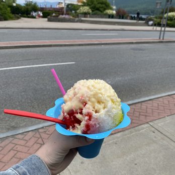 Hawaiian Shaved Ice - a hand holding up a blue plate with a scoop of ice cream and strawberries - Shaved Ice Near Me - Lake George, New York Hawaiian Shaved Ice - a hand holding up a blue plate with a scoop of ice cream and strawberries - Shaved Ice Near Me - Lake George, New York