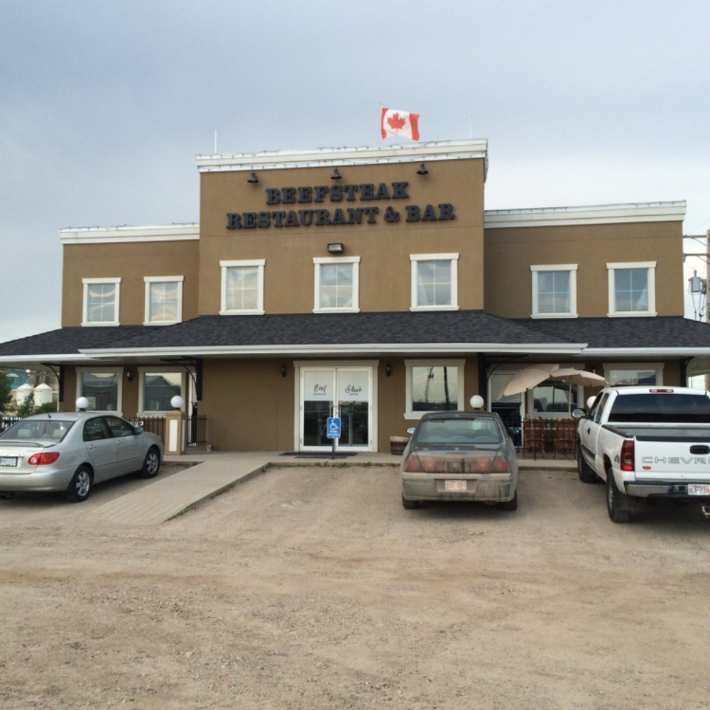Beef Steak Restaurant & Bar - cars parked outside - Bars Near Me - Beiseker, Alberta