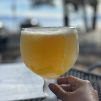 Jason's Beachside Grille - a person holding a glass of beer - New American Near Me - Kings Beach, California Jason's Beachside Grille - a person holding a glass of beer - New American Near Me - Kings Beach, California