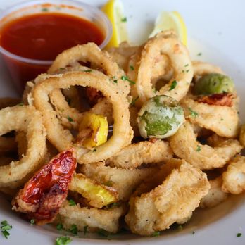 Uccello's - Rockford - Golden fried calamari paired with fried green olives, roasted tomatoes, and a side of marinara sauce for dipping, offering a ... - Pizza Near Me - Rockford, Michigan Uccello's - Rockford - Golden fried calamari paired with fried green olives, roasted tomatoes, and a side of marinara sauce for dipping, offering a ... - Pizza Near Me - Rockford, Michigan