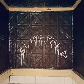 Scratcher - graffiti on the wall of a bathroom - Bars Near Me - New York, New York