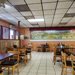 a restaurant with tables and chairs a restaurant with tables and chairs