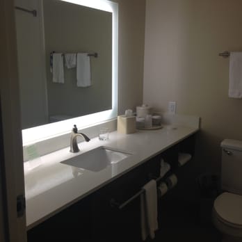 Holiday Inn Express - Note the location of the towel bar in front of sink. Hits you in the knees every time. Also the light is not very bright - Hotels Near Me - Bellingham, Washington Holiday Inn Express - Note the location of the towel bar in front of sink. Hits you in the knees every time. Also the light is not very bright - Hotels Near Me - Bellingham, Washington