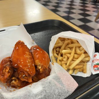 Wings N Tings - Close-up shot of Buffalo wings and french fries. - Chicken Wings Near Me - Irving, Texas