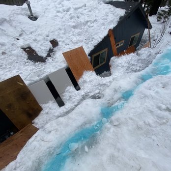 McGowan Builders - Edge of roof that had snow buildup threatening neighbor's home/windows - Handyman Near Me