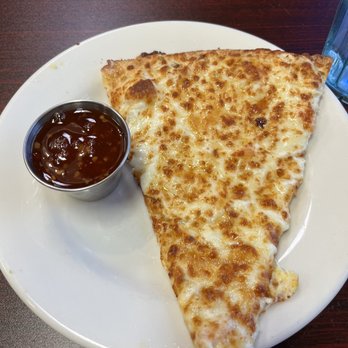 Pizza West - The slice of Crab Rangoon Pizza. Very bland and crust undercooked. The sweet chili sauce was super spicy. No balance. - Pizza Near Me - Omaha, Nebraska