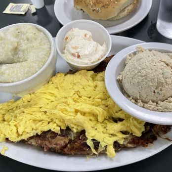Bagelworks - Carnegie corned beef hash with eggs and grits  Also pictured: scoop of legendary tuna salad - Bagels Near Me - Boca Raton, Florida