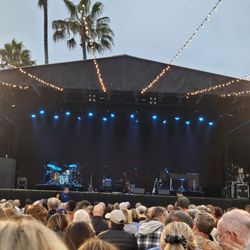 Humphreys Concerts By The Bay - Seated shoulder to shoulder on white folding chairs.
