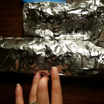 Planet Sub - a hand holding a piece of foil - Sandwiches Near Me - Mission, Kansas Planet Sub - a hand holding a piece of foil - Sandwiches Near Me - Mission, Kansas