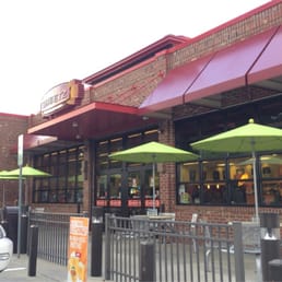 the outside of a restaurant with green umbrellas