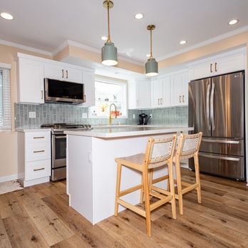 So Cal Builders and Design - A full kitchen remodel featuring new sleek white shaker cabinets, a pristine white quartz countertop, and a green tile backsplash - General Contractors Near Me - Studio City, California So Cal Builders and Design - A full kitchen remodel featuring new sleek white shaker cabinets, a pristine white quartz countertop, and a green tile backsplash - General Contractors Near Me - Studio City, California