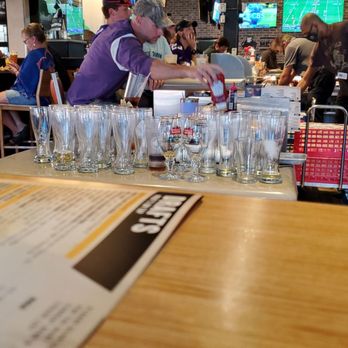 Buffalo Wild Wings - a bartender pouring a drink at a bar - Chicken Wings Near Me - Aurora, Colorado