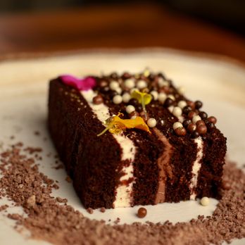 Koya - a piece of chocolate cake on a plate - Lounges Near Me - Houston, Texas Koya - a piece of chocolate cake on a plate - Lounges Near Me - Houston, Texas