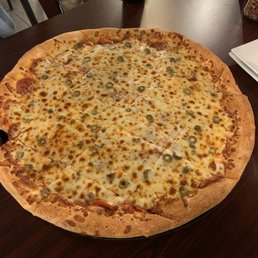 a large pizza on a wooden table
