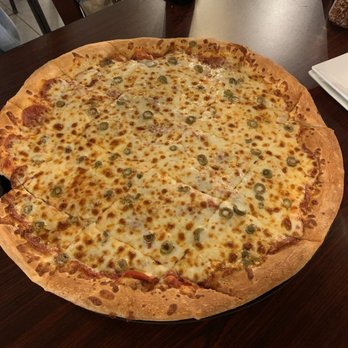 Giovanni's Pizza - a large pizza on a wooden table - Pizza Near Me - Huntington, West Virginia