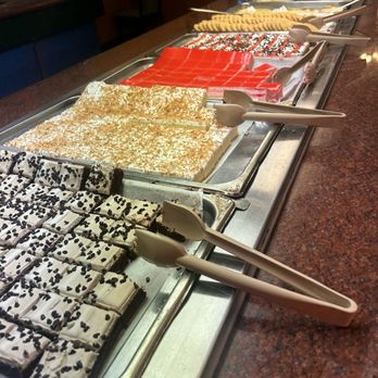 King Buffet - Desserts - A variety of desserts such as brownies with black sprinkles, layered cakes with red and white icing, and cookies are arranged on a buffet tray at King Buffet. - Buffets Near Me - Richmond, Kentucky