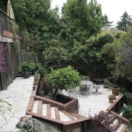 a patio with steps leading up to a deck