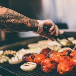 Fresh tomatoes, onions, peppers, and other vegetables are grilled to bring out bold flavor before being served in Tacoria's m...