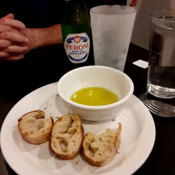 Fiamme Pizza - Crusty bread and olive oil with Peroni in a frosted glass. - Pizza Near Me - Tucson, Arizona Fiamme Pizza - Crusty bread and olive oil with Peroni in a frosted glass. - Pizza Near Me - Tucson, Arizona