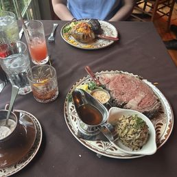 Prime rib medium rare with wild rice. The remaining soup that was used on the prime rib dinner to the left.
