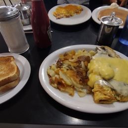The Florentine Omelette Spinach, mushroom, ham,  swiss with a hollandaise sauce. Home style potatoes and sourdough toast