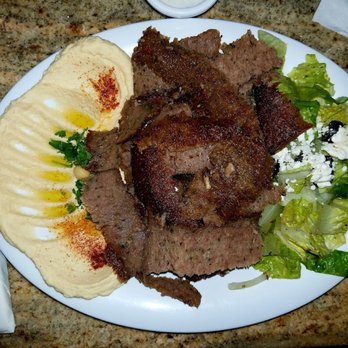 Phoenician Resto Cafe - Gyro Plate entree with Hummus and Greek salad, served with that delicious Tzatziki sauce - Lebanese Near Me - Austin, Texas Phoenician Resto Cafe - Gyro Plate entree with Hummus and Greek salad, served with that delicious Tzatziki sauce - Lebanese Near Me - Austin, Texas