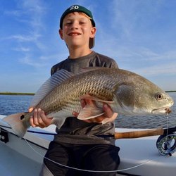 Off The Hook Fishing Charters - My son Connor (6) with his red fish caught on a fly rod!