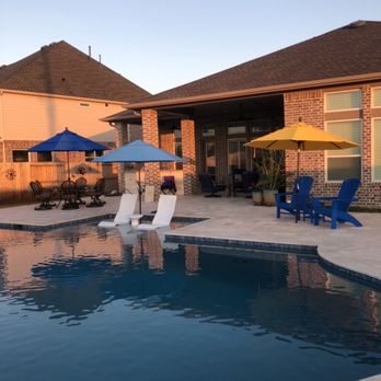 Cypress Custom Pools - a pool with lounge chairs and umbrellas - General Contractors Near Me - Tomball, Texas Cypress Custom Pools - a pool with lounge chairs and umbrellas - General Contractors Near Me - Tomball, Texas