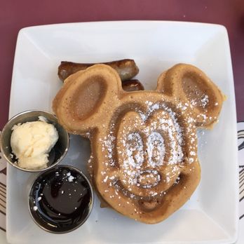 Carnation Cafe - Mickey-shaped waffle $12 (choice of sausage or bacon) - American Near Me - Anaheim, California