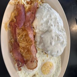 3 eggs, bacon, hash browns, and the king of all sausage gravy smothering 2 biscuits 3 eggs, bacon, hash browns, and the king of all sausage gravy smothering 2 biscuits