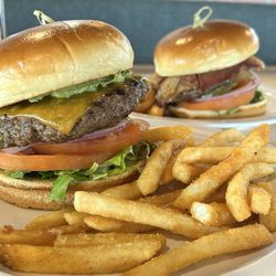 Sage Cafe - Regular burger with cheddar and avocado slices and Cobb burger with thick sliced bacon and blue cheese crumbles.