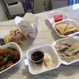 Steamed dumplings, sesame chicken w/ white rice & crab Rangoon. Steamed dumplings, sesame chicken w/ white rice & crab Rangoon.