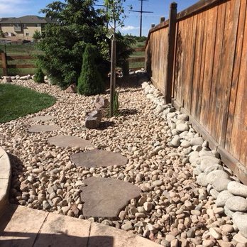 Rock Landscaping - a garden with a stone path and a wooden fence - Landscaping Near Me - Castle Rock, Colorado Rock Landscaping - a garden with a stone path and a wooden fence - Landscaping Near Me - Castle Rock, Colorado